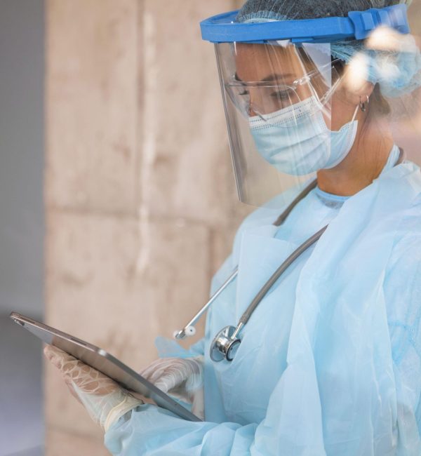 sideways female doctor looking clipboard